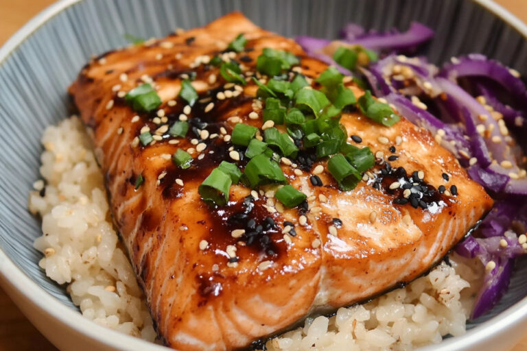 Teriyaki salmon bowl with grilled salmon, rice, vegetables, and teriyaki sauce.